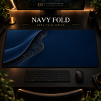 Navy Fold desk mat with a sweeping curve and fine contours along the left in a warm, dark workspace.