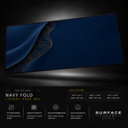 Navy Fold desk mat floating against a dark studio background.