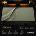 Sage Fold desk mat in a dark workstation with warm monitor lighting.