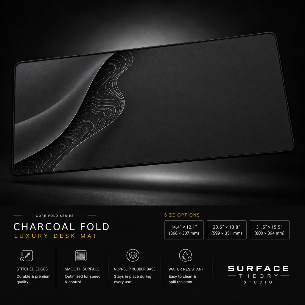 Charcoal Fold desk mat floating against a dark studio background.
