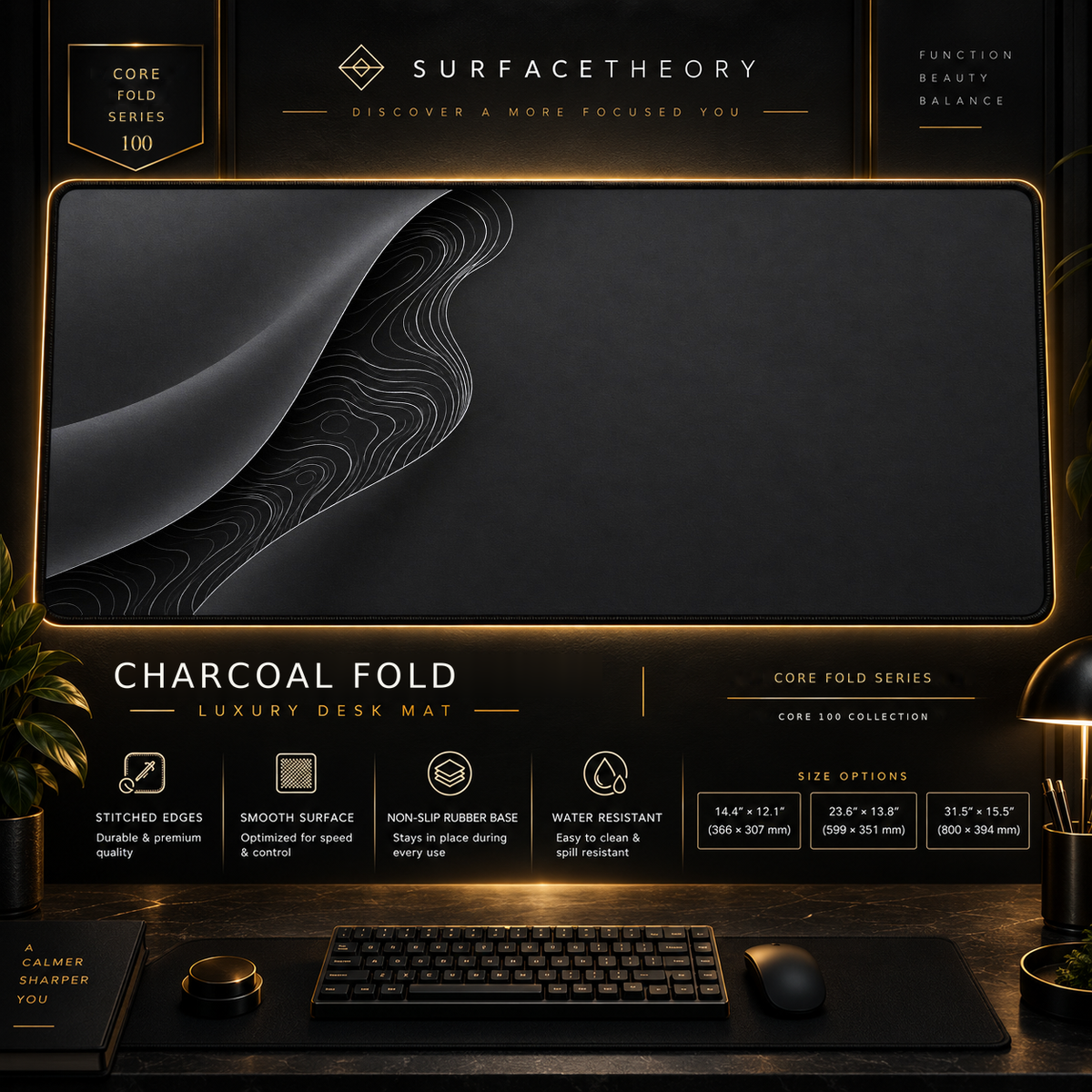 Charcoal Fold desk mat in a gold-toned showcase frame above a keyboard.
