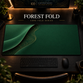 Forest Fold desk mat with a sweeping curve and fine contours along the left in a warm, dark workspace.