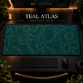 Teal Atlas desk mat with fine topographic-inspired contours across the full surface in a warm, dark workspace.