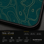 Close-up of Teal Atlas printed artwork and black stitched corner.