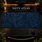 Navy Atlas desk mat with fine topographic-inspired contours across the full surface in a warm, dark workspace.