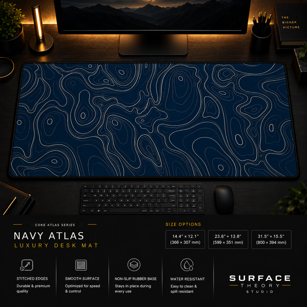 Navy Atlas desk mat in a dark workstation with warm monitor lighting.