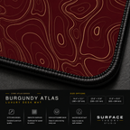 Close-up of Burgundy Atlas printed artwork and black stitched corner.
