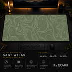 Sage Atlas desk mat in a dark workstation with warm monitor lighting.