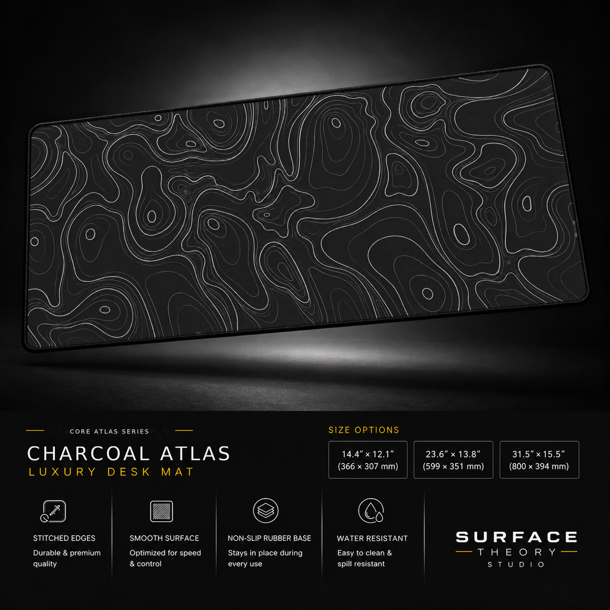 Charcoal Atlas desk mat floating against a dark studio background.