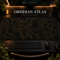 Obsidian Atlas desk mat with fine topographic-inspired contours across the full surface in a warm, dark workspace.