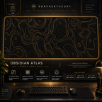 Obsidian Atlas desk mat in a gold-toned showcase frame above a keyboard.