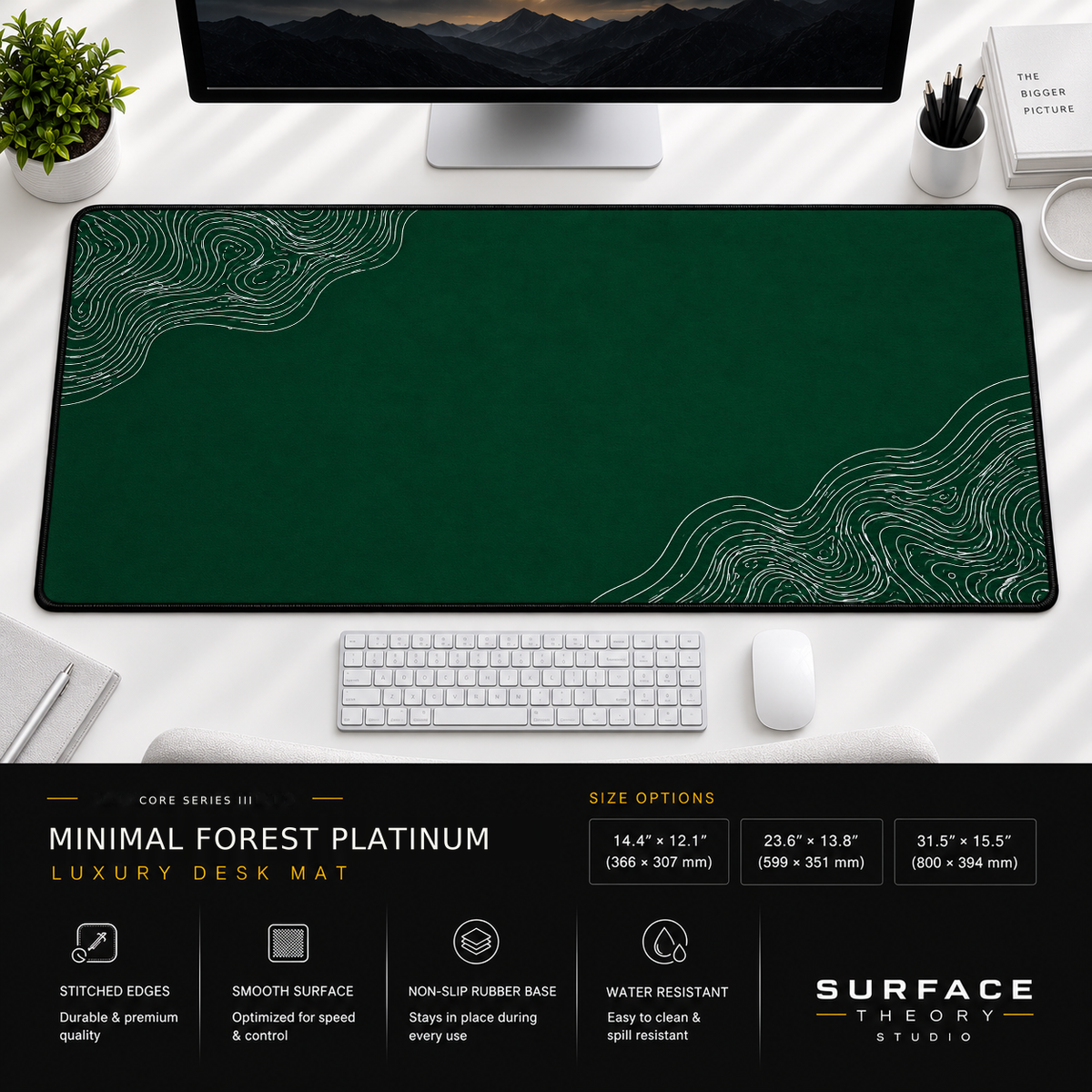 Minimal Forest Platinum desk mat beneath a monitor on a bright desk with a white keyboard and mouse.
