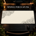 Minimal Porcelain Ink desk mat with fine contours in opposing corners in a warm, dark workspace.