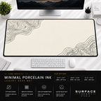 Minimal Porcelain Ink desk mat beneath a monitor on a bright desk with a white keyboard and mouse.