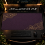 Minimal Aubergine Gold desk mat with fine contours in opposing corners in a warm, dark workspace.