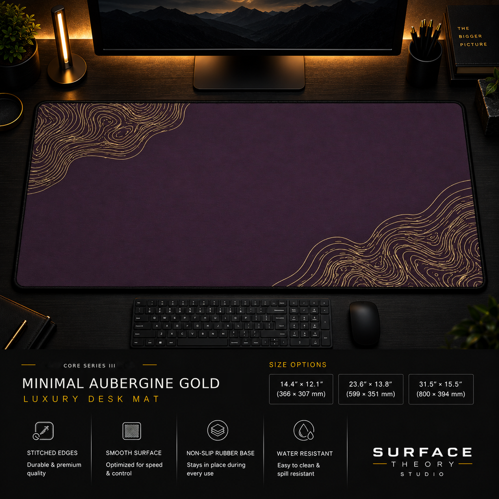 Minimal Aubergine Gold desk mat in a dark workstation with warm monitor lighting.