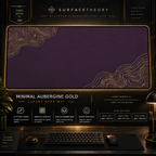Minimal Aubergine Gold desk mat in a gold-toned showcase frame above a keyboard.