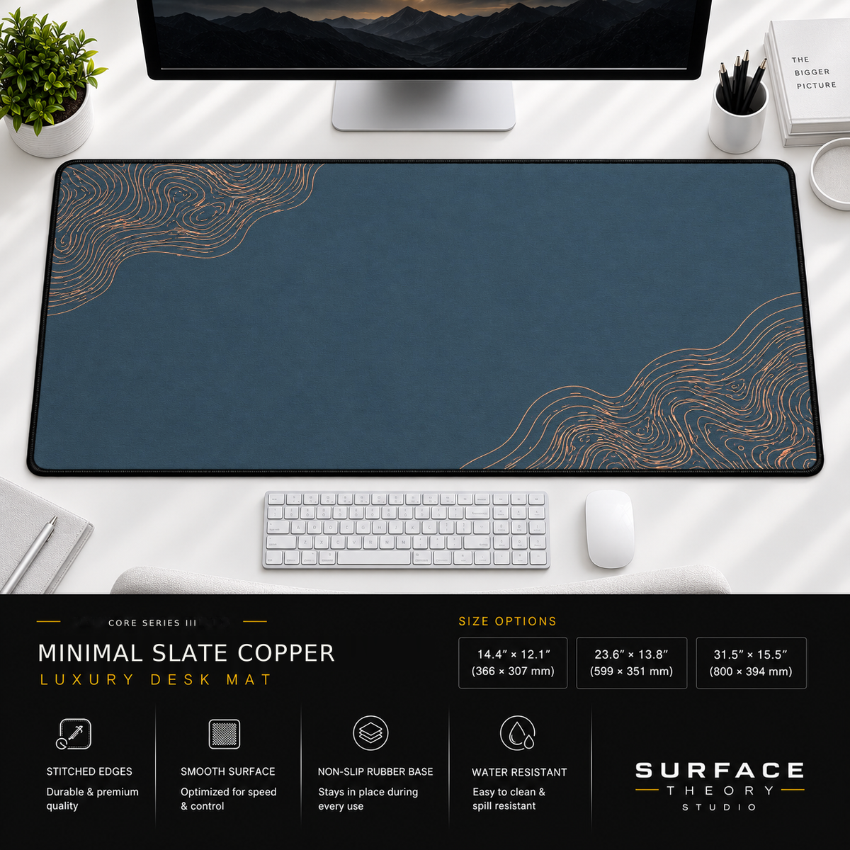 Minimal Slate Copper desk mat beneath a monitor on a bright desk with a white keyboard and mouse.