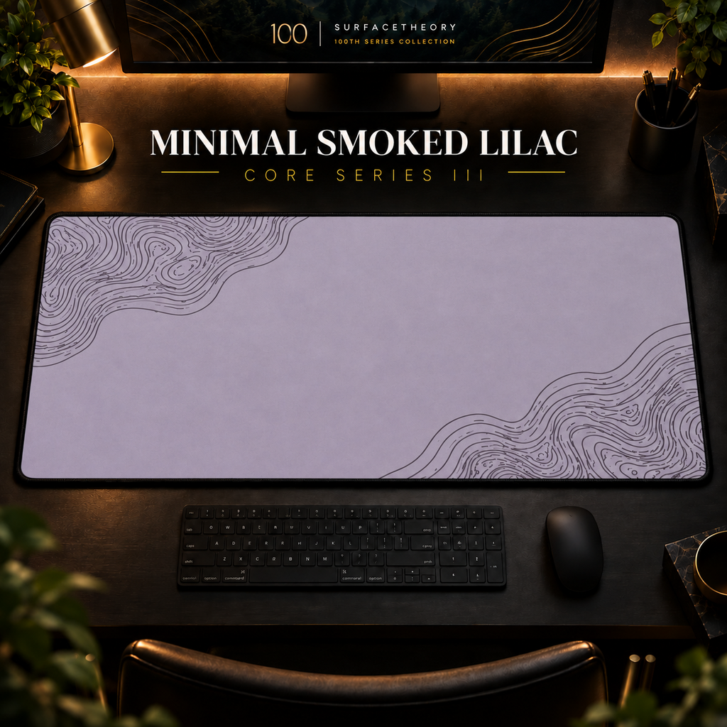 Minimal Smoked Lilac desk mat with fine contours in opposing corners in a warm, dark workspace.