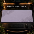 Minimal Smoked Lilac desk mat with fine contours in opposing corners in a warm, dark workspace.