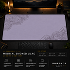 Minimal Smoked Lilac desk mat in a dark workstation with warm monitor lighting.
