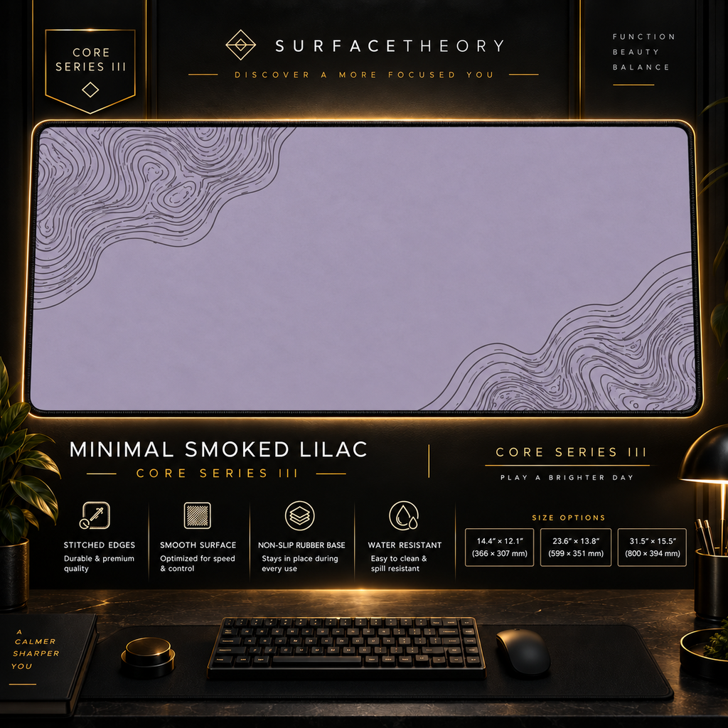 Minimal Smoked Lilac desk mat in a gold-toned showcase frame above a keyboard.