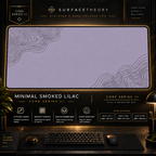 Minimal Smoked Lilac desk mat in a gold-toned showcase frame above a keyboard.
