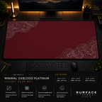 Minimal Oxblood Platinum desk mat in a dark workstation with warm monitor lighting.