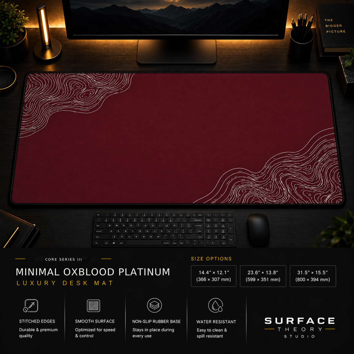 Minimal Oxblood Platinum desk mat in a dark workstation with warm monitor lighting.