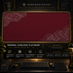 Minimal Oxblood Platinum desk mat in a gold-toned showcase frame above a keyboard.