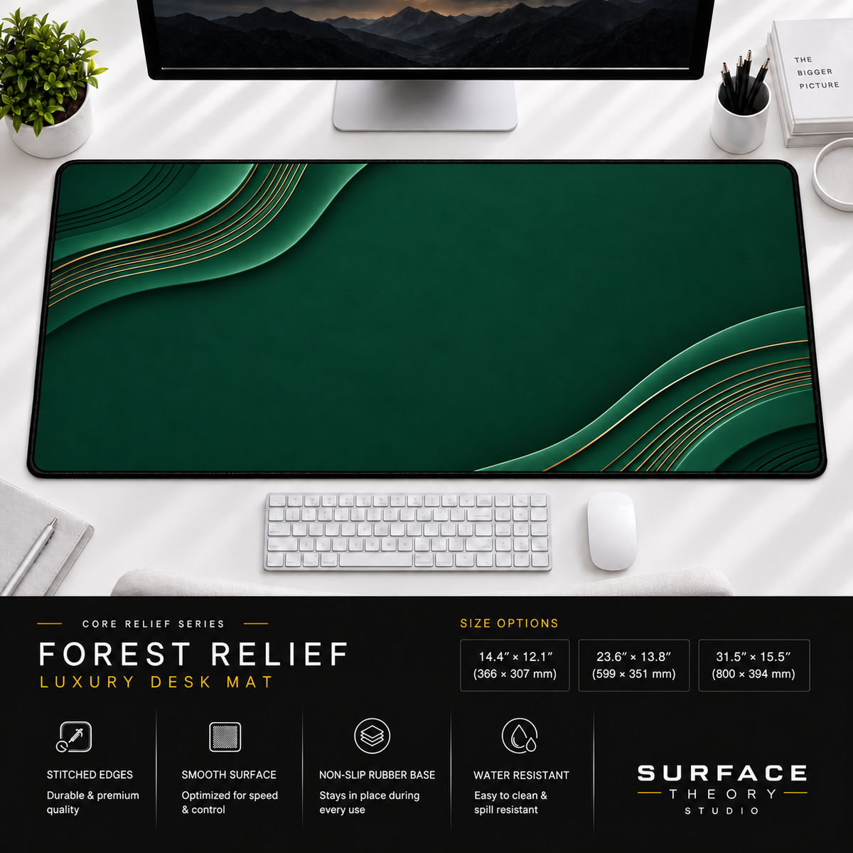 Forest Relief desk mat beneath a monitor on a bright desk with a white keyboard and mouse.