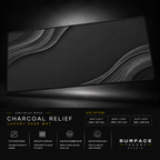 Charcoal Relief desk mat floating against a dark studio background.