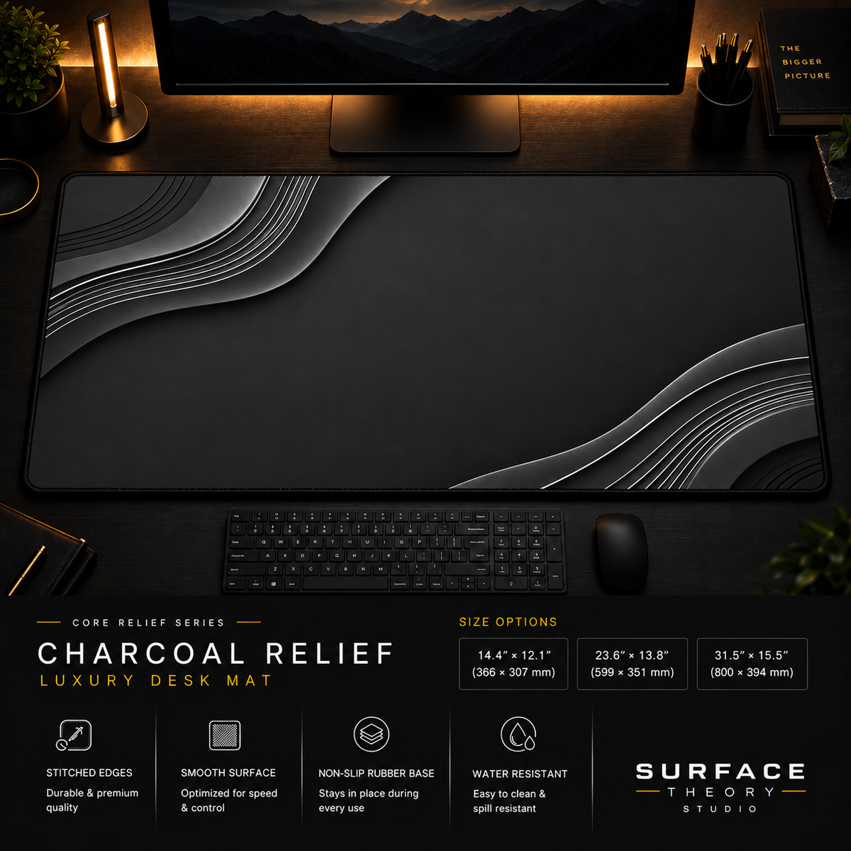 Charcoal Relief desk mat in a dark workstation with warm monitor lighting.