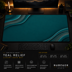 Teal Relief desk mat in a dark workstation with warm monitor lighting.