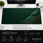 Forest Facet desk mat beneath a monitor on a bright desk with a white keyboard and mouse.