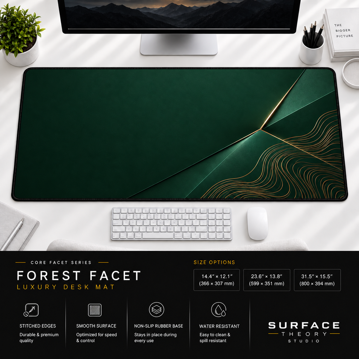 Forest Facet desk mat beneath a monitor on a bright desk with a white keyboard and mouse.