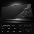 Charcoal Facet desk mat floating against a dark studio background.