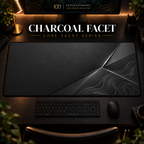 Charcoal Facet desk mat in a warm, dark workspace.
