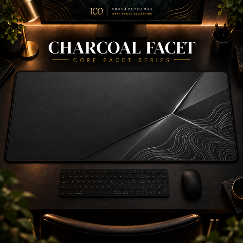 Charcoal Facet desk mat in a warm, dark workspace.