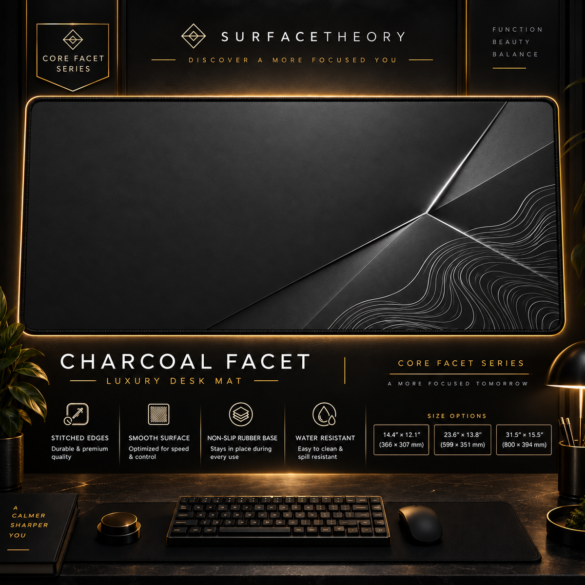 Charcoal Facet desk mat in a gold-toned showcase frame above a keyboard.