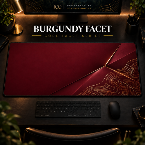 Burgundy Facet desk mat in a warm, dark workspace.