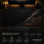 Obsidian Facet desk mat in a dark workstation with warm monitor lighting.