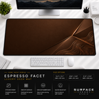 Espresso Facet desk mat beneath a monitor on a bright desk with a white keyboard and mouse.