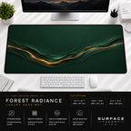 Forest Radiance desk mat beneath a monitor on a bright desk with a white keyboard and mouse.