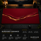 Burgundy Radiance desk mat in a dark workstation with warm monitor lighting.
