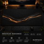 Obsidian Radiance desk mat in a dark workstation with warm monitor lighting.
