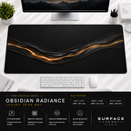 Obsidian Radiance desk mat beneath a monitor on a bright desk with a white keyboard and mouse.