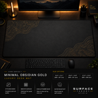 Minimal Obsidian Gold desk mat in a dark workstation with warm monitor lighting.