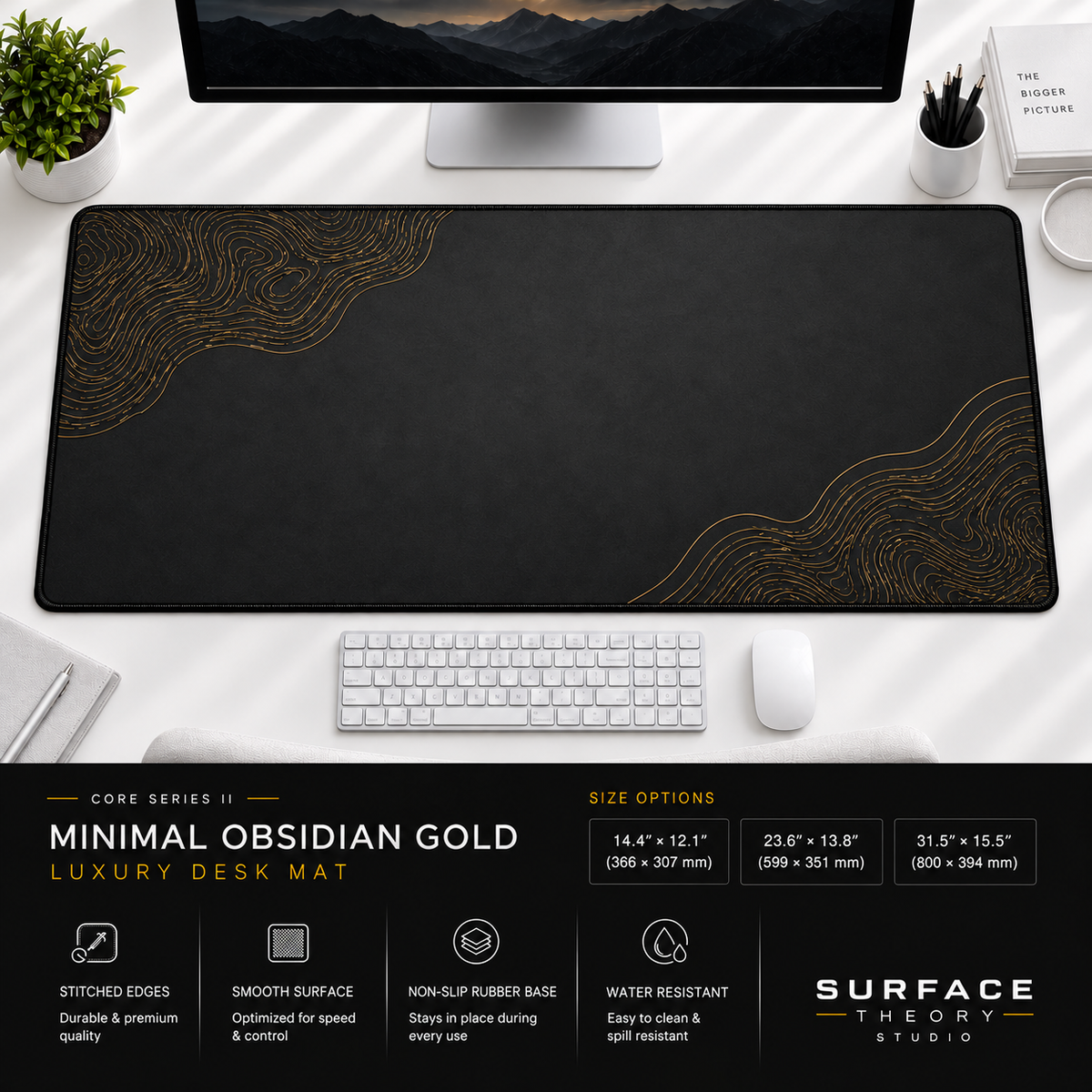 Minimal Obsidian Gold desk mat beneath a monitor on a bright desk with a white keyboard and mouse.