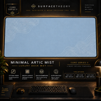 Minimal Artic Mist desk mat in a gold-toned showcase frame above a keyboard.